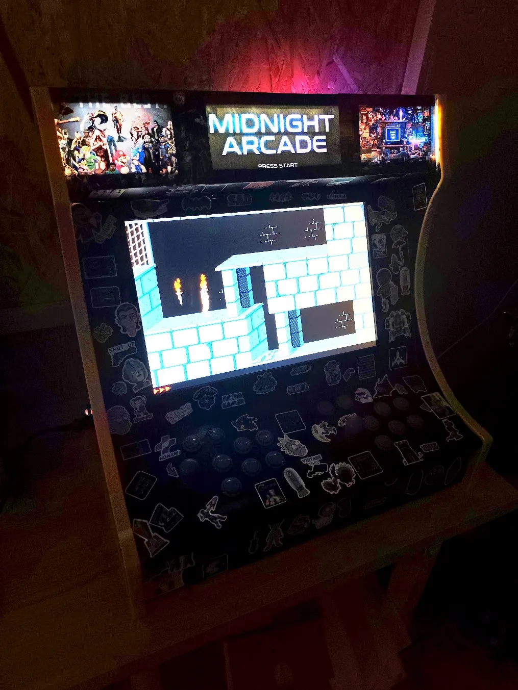The arcade machine running a retro game in the dark